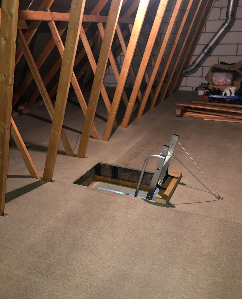 Loft boarding installation in progress with wooden boards laid over insulation
