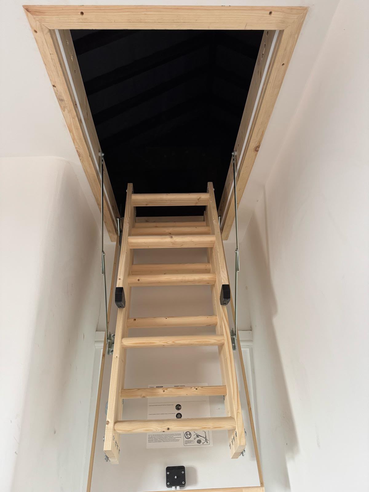 Timber loft ladder lowered onto a landing